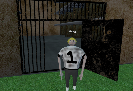 An HMPen inmate standing outside the prison's barred gates